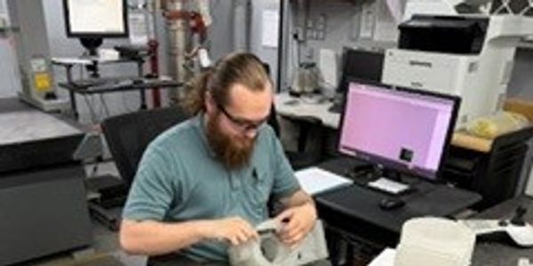 Man working with mechanical parts in workshop.