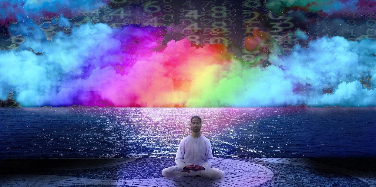 man deep in meditation with psychedelic background