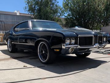 black old school car fully restored shining in the sun