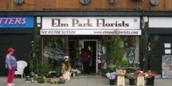 Flower shop entrance with colorful floral displays outside.