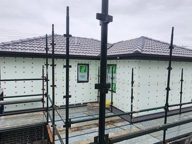 House under construction with scaffolding around.