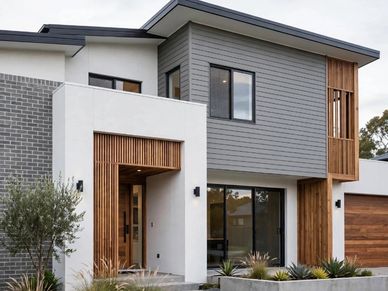 Modern two-story house with wood and grey accents.