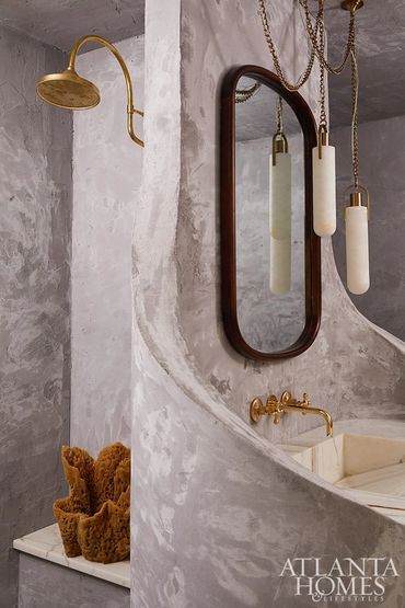 Marble Clad bathroom into a retreat with striking, sculptural details and bold design choices