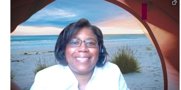 Video screen shot of Lisa Dance, an African American woman smiling