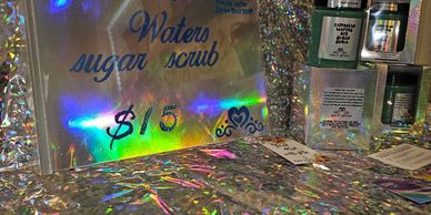 A sign advertising waters sugar scrub for $15.