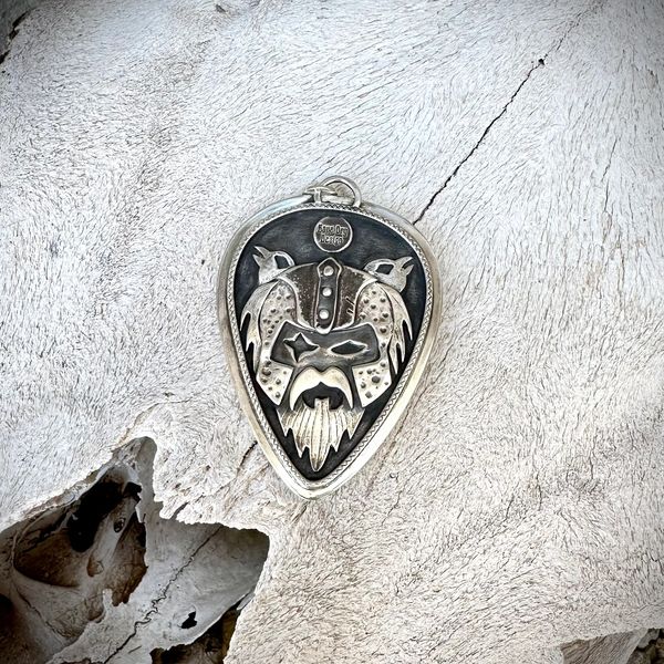 The back of a large pendant with Odins face and his ravens Huginn and Muninn behind him.