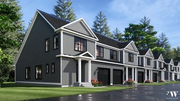 Modern gray townhouses with white trim and black garage doors under a clear sky.