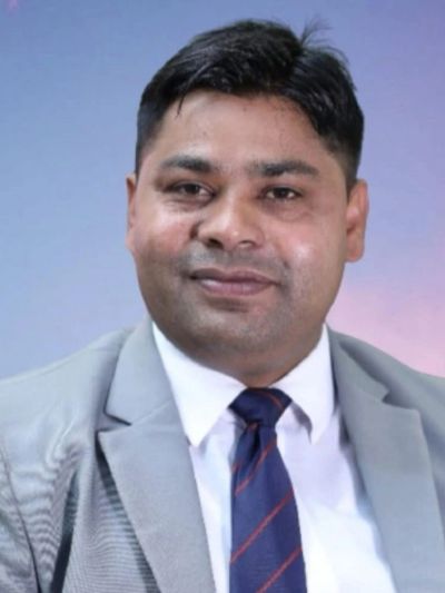 Portrait of a man in a suit and tie against a gradient background.