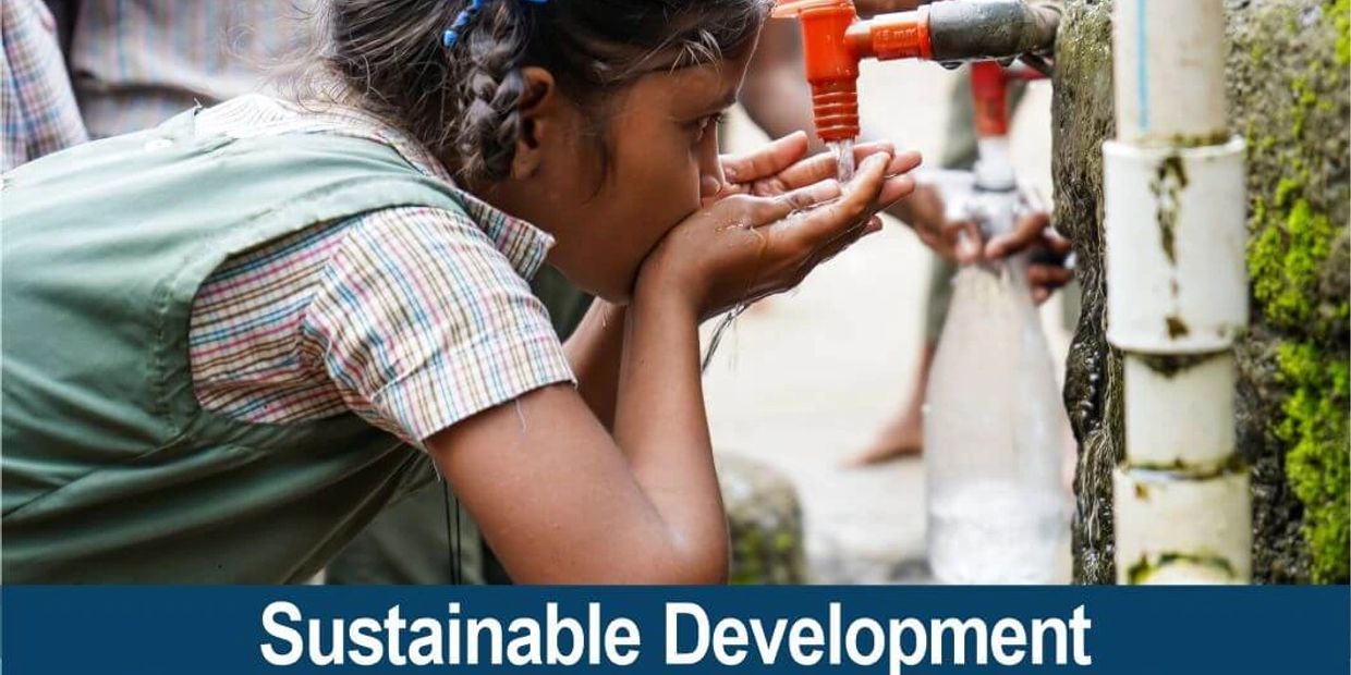 A young girl drinks clean water from a tap, highlighting Sustainable Development Goal 6.