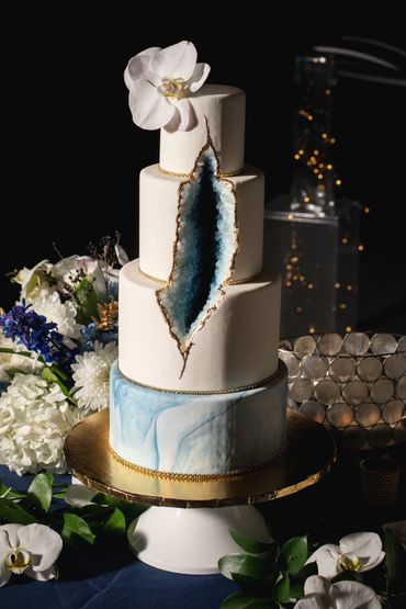 Geode wedding cake in blue and white with a phaleonopsis orchid cake topper