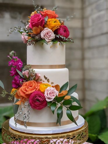 wedding cake with orange and pink flowers 