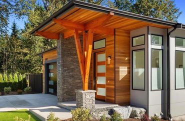 Modern entry with Cowboy Coffee Ledgestone Thin Veneer columns and accent wall for bold contrast.