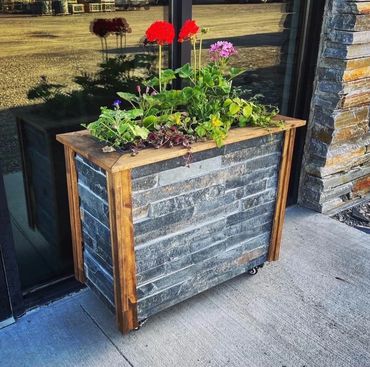 Planter box clad in Iron Mountain Classic Planking 2" strips adds rustic style and modern contrast.