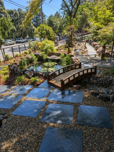 Black limestone pavers with Sonoma Fieldstone, Yosemite Cobble, and a Desert Flat stone spillway.