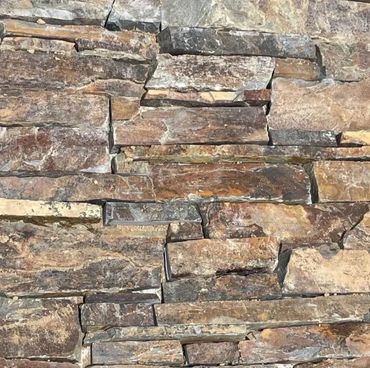 Wall with Stampede Ledgestone Thin Veneer featuring rich browns, grays, and natural linear texture.