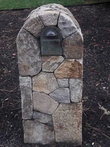 Decorative mailbox enclosure built with Moon Valley (Willow Creek) stone in custom ashlar pattern.