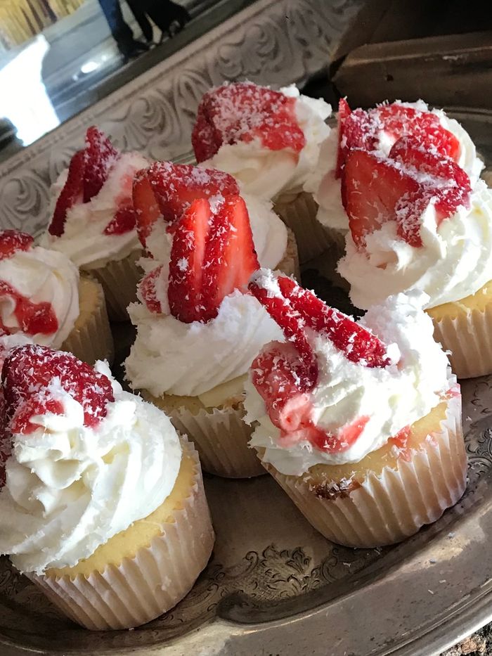 White Chocolate Cupcake with Strawberry Filling. Topped Whipped Cream Frosting.