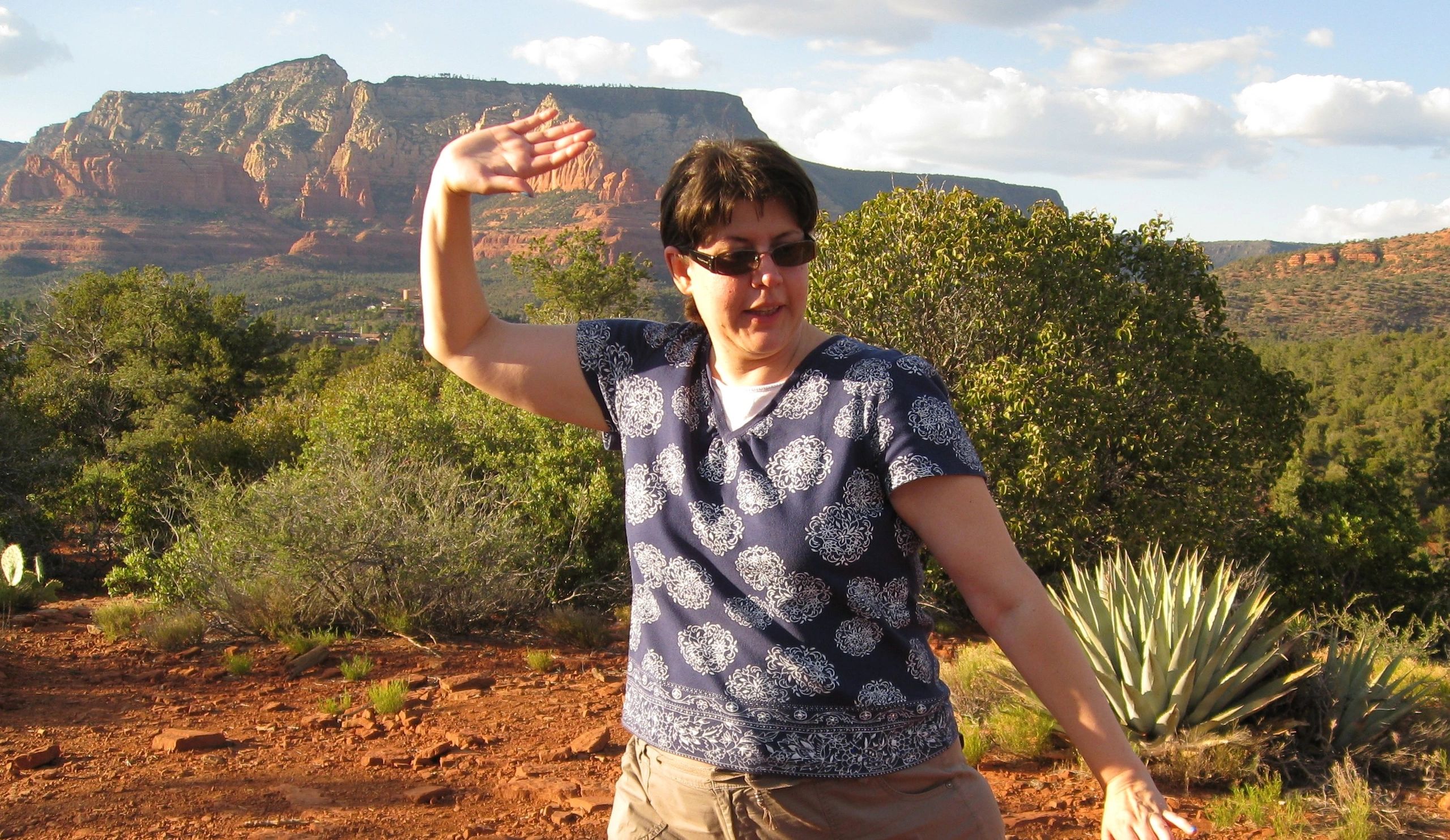 Woman practicing Tai Chi with the landscape of Sedona in the background