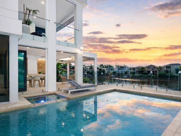Modern house with pool at sunset.