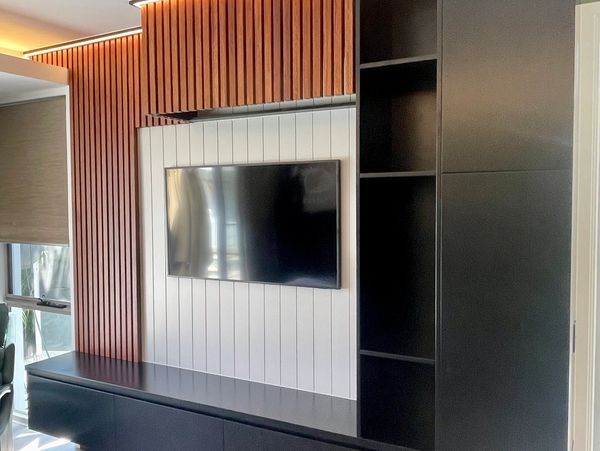 Modern entertainment center with TV and built-in shelves.