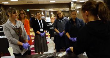 crowd of people gathered around woman, Dr. Sarina Barbara, at an ozone therapy training workshop