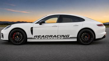 White Porsche with Readracing Remapping decal on side at sunset.