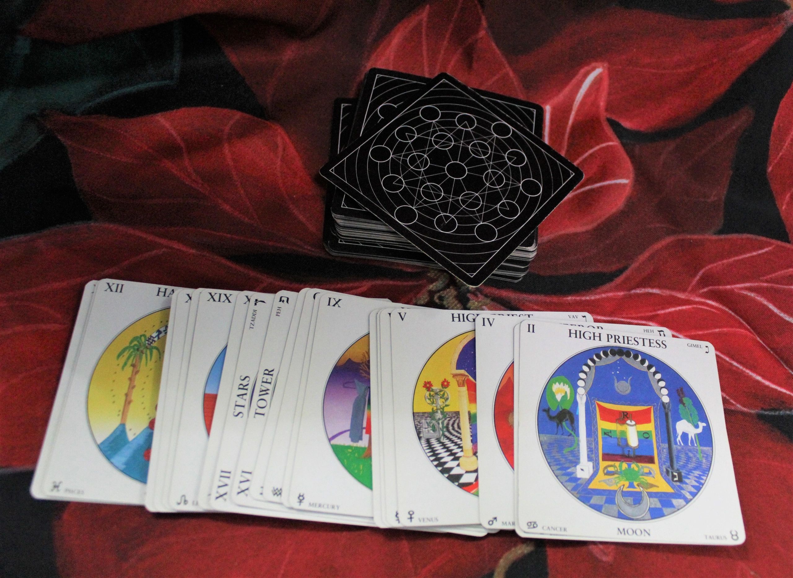 Deck of Tarot cards spread on red cloth