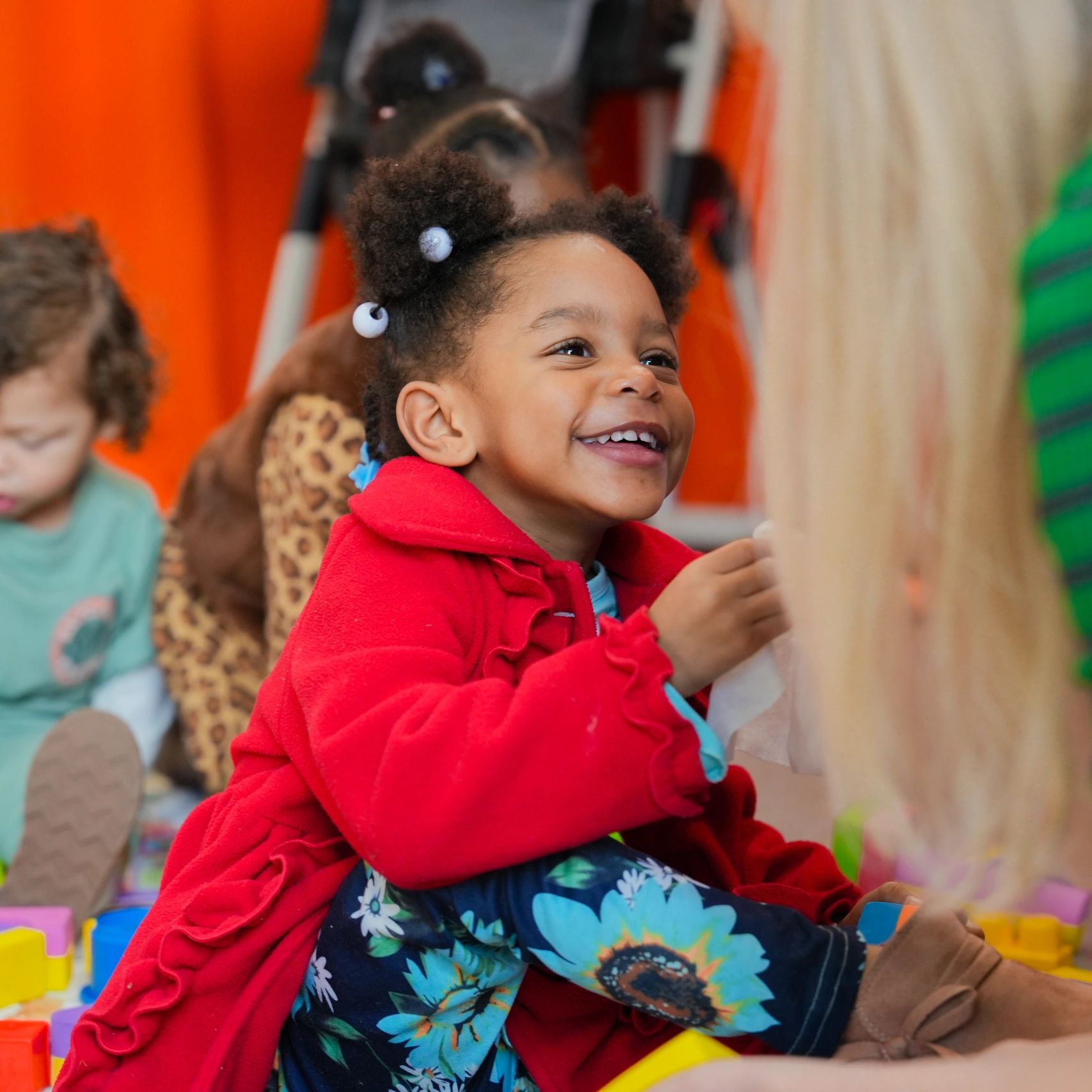 Little girl smiles at kids church in Momentum Kids