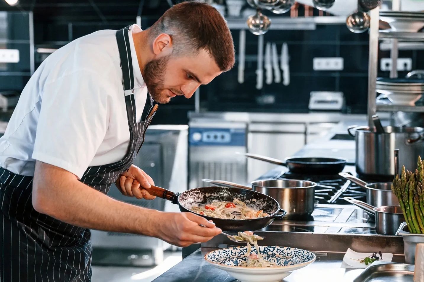 chef preparing food in a professional commercial kitchen