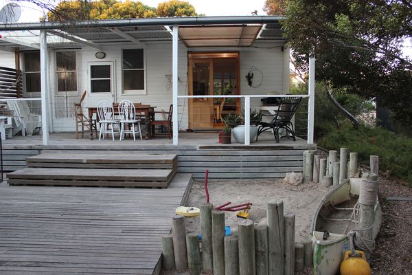 Outdoor entertaining with a deck, BBQ, outdoor dining and kids play area.