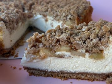 Close-up of a crumb-topped cheesecake slice.