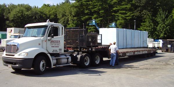 tractor-trailer truck with a low-bed trailer hauling equipment