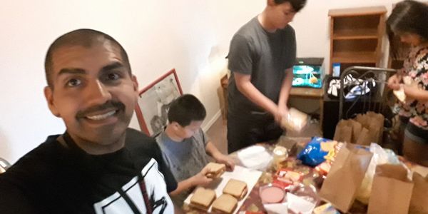 Group preparing food around a table.