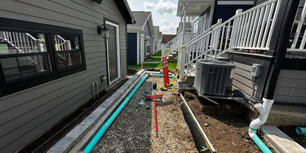 Drainage below permeable pavers and gutter downspouts