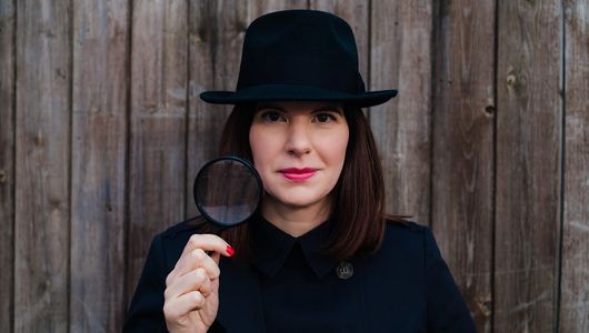Fiona Lomas, Founder & Director of The Brand Detectives, shown wearing detective-themed outfit.