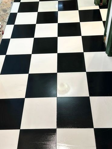 Black and white checkered floor tiles in a hallway.