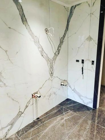 Marble-patterned wall and floor in a modern, unfinished room.