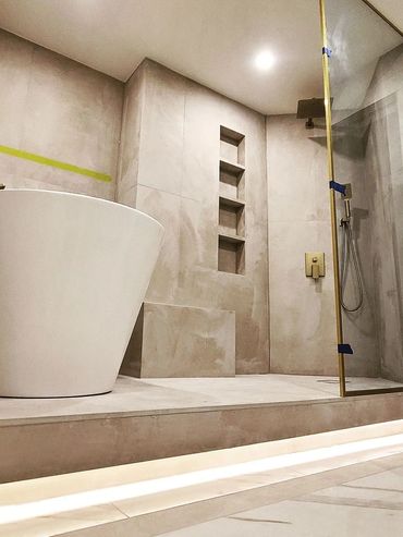 Modern bathroom with a freestanding tub and glass shower enclosure.