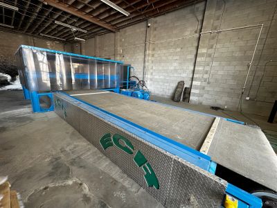 Large blue industrial machine in a warehouse.