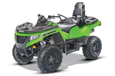 Green Arctic Cat Alterra ATV with rugged tires and comfortable seating for two.