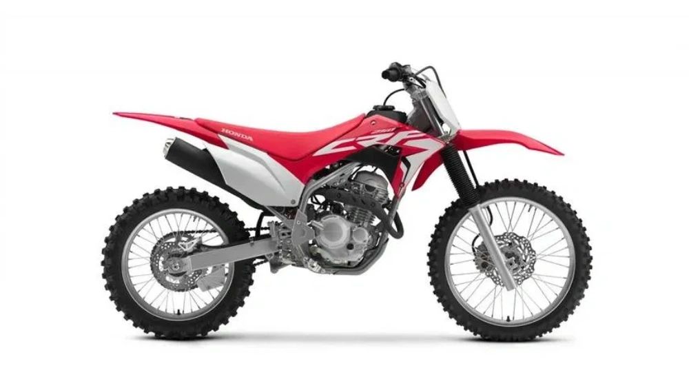 Red and white Honda dirt bike with knobby tires and visible engine. Honda CRF 125F
Honda CRF 250F