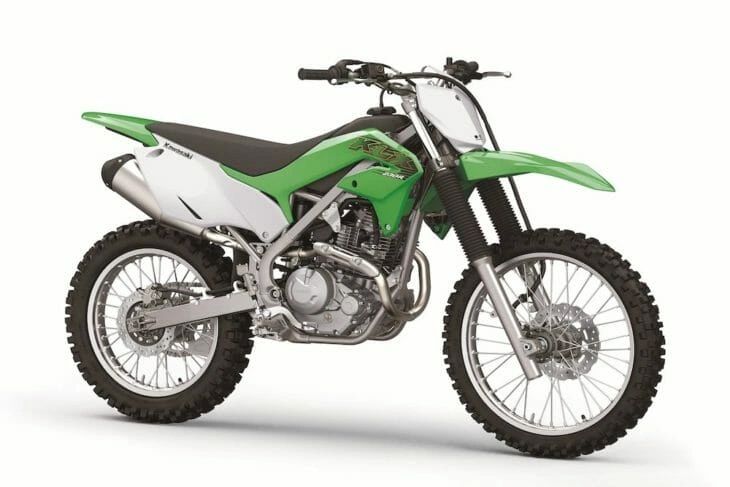 Green and white Kawasaki dirt bike with knobby tires. Kawasaki KLX 230R