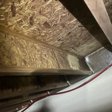 Detail shot of crawl space wood joist remediation and subfloor inspection after mold removal service