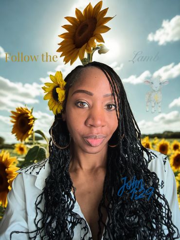 Woman with sunflowers in her hair in a sunflower field under a sunny sky.
