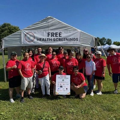 Group photo at free health screenings event outdoors.