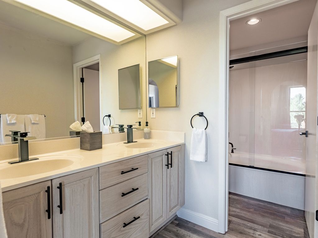 Master bathroom on main floor with  dual vanities, jacuzzi tub and shower