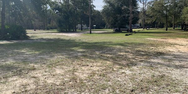 Wide-open park with RV campsites in the background.
