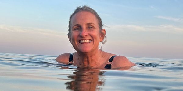 Head and shoulders photo of Juliet sea swimming., calm sea and muted colours