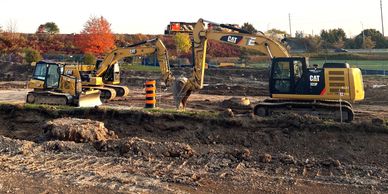 Three types of heavy equipment on a job site