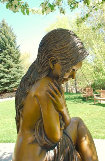 Figurative female life size bronze statue by figurative & equine bronze sculptor, J. Anne Butler.